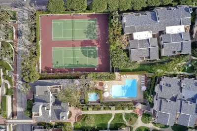 an aerial view of a house with a tennis court at Oceanfront Fully Remodeled 2BR 2BA, Pool, Hot Tub, Gated Parking in Solana Beach