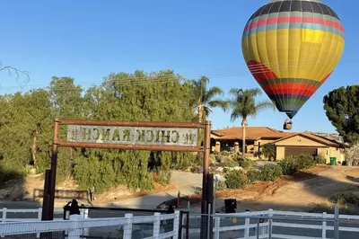 a hot air balloon flying over a sign in front of a house at Chick-Ranch Guest House in Temecula