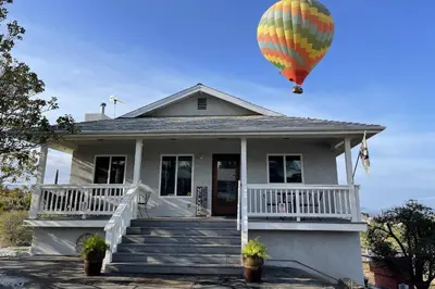 a hot air balloon flying over a house at Chick-Ranch Guest House in Temecula