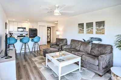 a living room with a couch and a table at San Clemente Condo with Gorgeous Views Near Beach! in San Clemente