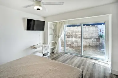 a bedroom with a bed and a large window at San Clemente Condo with Gorgeous Views Near Beach! in San Clemente
