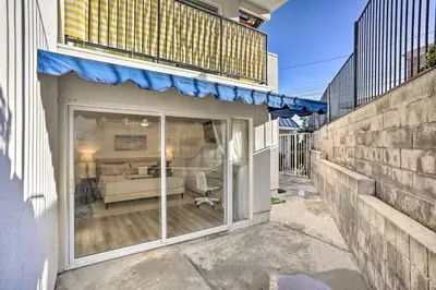 a sliding glass door of a building with a bedroom at San Clemente Condo with Gorgeous Views Near Beach! in San Clemente
