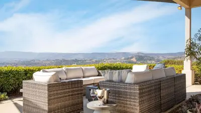 a patio with two wicker chairs and a table at Modern Temecula Mansion w Pool Hot Tub Guest House Valley Views Camila by AvantStay in Temecula