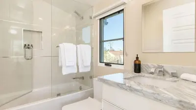 a white bathroom with a tub and a sink and a shower at Sea Crown by AvantStay 5mins from the Beach w Multiple Terraces PermitSLP13639 in Newport Beach