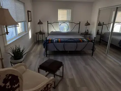 a bedroom with a bed and a living room at Aviation Landing in Fallbrook