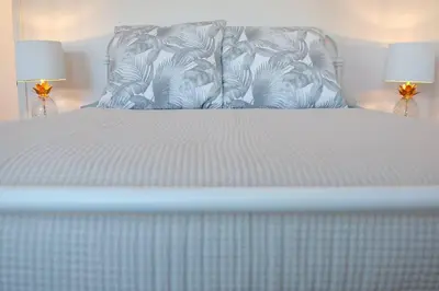 a white bed with two lamps on top of it at Aviation Landing in Fallbrook