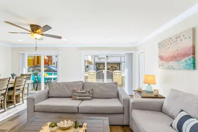 a living room with a couch and a ceiling fan at 4912 Seashore A Lower in Newport Beach