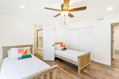a bedroom with two beds and a ceiling fan at 4912 Seashore A Lower in Newport Beach