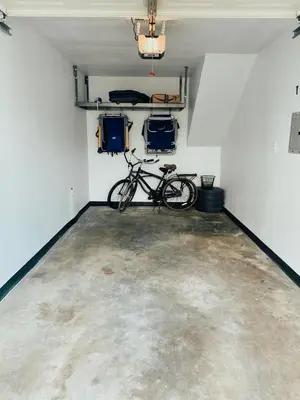 a bike is parked in a room with a garage at Beach house in the heart of balboa peninsula in Newport Beach