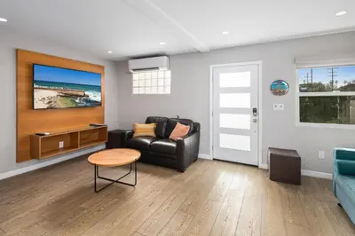 a living room with a couch and a table at Newly Renovated 3BR Modern Apt in Heart of Ocean Beach in San Diego