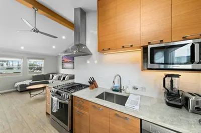 a kitchen with a sink and a stove top oven at Modern Newly Renovated 2BR Apt in Heart of Ocean Beach in San Diego