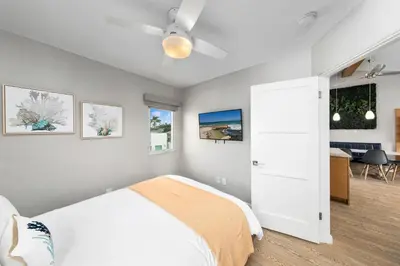 a bedroom with a bed and a ceiling fan at Modern Newly Renovated 2BR Apt in Heart of Ocean Beach in San Diego