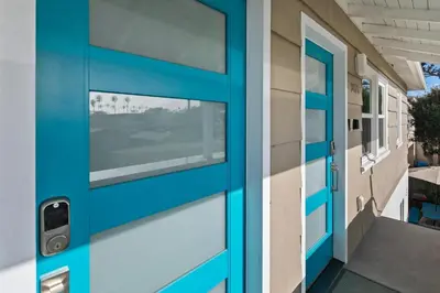 a blue door of a building with a window at Modern Luxury 2BR Apt in Heart of Ocean Beach in San Diego