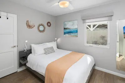 a white bedroom with a bed and a window at 7BD Family, Event Friendly, 2 blocks to Beach, Boardwalk in San Diego