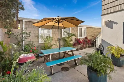 a picnic table with an umbrella and a bench at 7BD Family, Event Friendly, 2 blocks to Beach, Boardwalk in San Diego