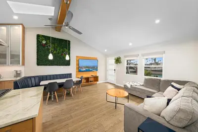 a living room and kitchen with a couch and a table at 7BD Family, Event Friendly, 2 blocks to Beach, Boardwalk in San Diego