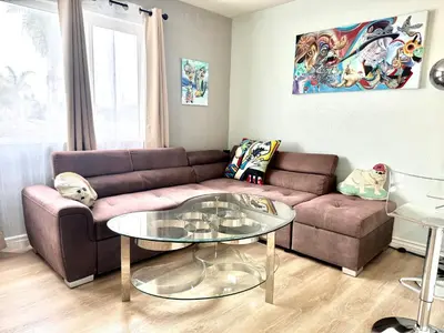 a living room with a couch and a glass table at Artsy smart home near Downtown & Balboa Park in San Diego