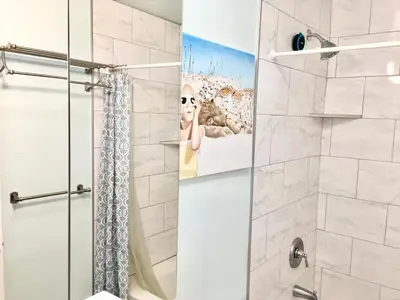 a bathroom with a shower with a shower curtain at Artsy smart home near Downtown & Balboa Park in San Diego