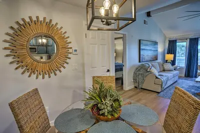 a living room with a table and chairs and a mirror at Cozy-Chic Condo Walk to Beach and Park! in Dana Point