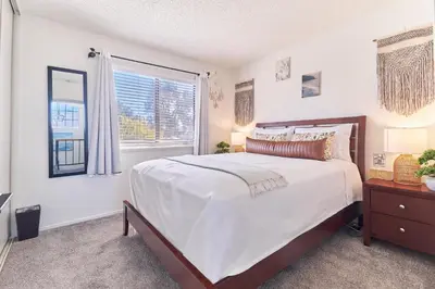 a bedroom with a large bed and a window at Entire Mountain Oasis Home in Hemet