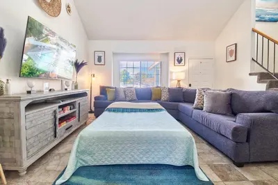 a living room with a blue couch and a tv at Entire Mountain Oasis Home in Hemet