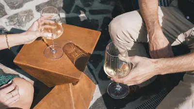 two people holding wine glasses on a table at Hidden Hacienda in Temecula