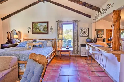 a bedroom with a bed and a desk in a room at Cozy Story Book Barn Cottage with Scenic View in Julian