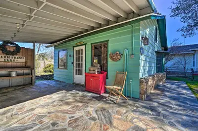 a green house with a red stove on a patio at Cozy Story Book Barn Cottage with Scenic View in Julian