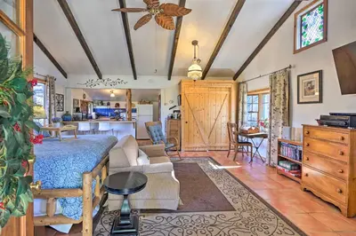 a living room with a couch and a table at Cozy Story Book Barn Cottage with Scenic View in Julian