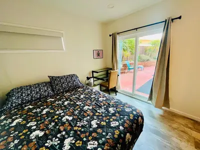 a bedroom with a bed and a sliding glass door at Private Room0 Own Bath Own Entry Shared Kitchen Walk to UCSD in San Diego