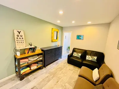 a living room with a couch and a table at Private Room0 Own Bath Own Entry Shared Kitchen Walk to UCSD in San Diego