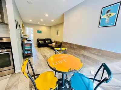 a living room with a yellow table and chairs at Private Room0 Own Bath Own Entry Shared Kitchen Walk to UCSD in San Diego