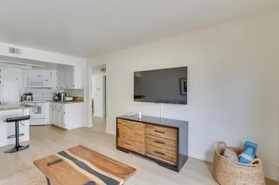 a living room with a tv and a kitchen at Bright Townhome in Carlsbad 1 Mile to Beach! in Carlsbad