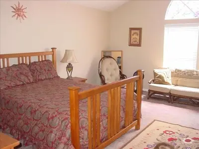 a bedroom with a bed and a couch and a window at the Newport Family Peninsula Beach House in Newport Beach
