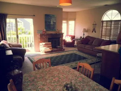 a living room with a couch and a fireplace at the Newport Family Peninsula Beach House in Newport Beach