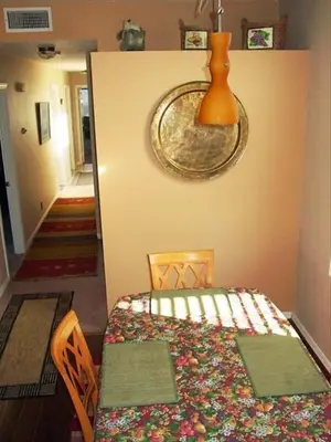 a dining room with a table and a vase on the wall at the Newport Family Peninsula Beach House in Newport Beach