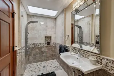 a bathroom with a sink and a shower and a mirror at Elevado Hills Family Getaway ~ Pool ~ Games ~ Pkg! in Vista