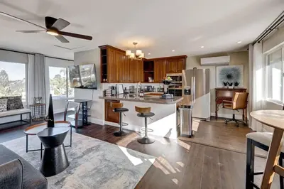 a kitchen and living room with a table and chairs at Elevado Hills Family Getaway ~ Pool ~ Games ~ Pkg! in Vista