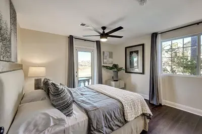 a bedroom with a bed and a ceiling fan at Elevado Hills Family Getaway ~ Pool ~ Games ~ Pkg! in Vista