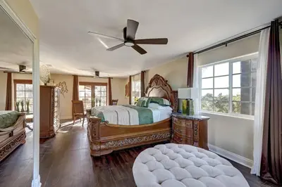a bedroom with a bed and a ceiling fan at Elevado Hills Family Getaway ~ Pool ~ Games ~ Pkg! in Vista