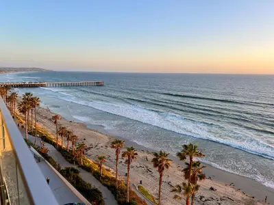 a view of a beach with palm trees and the ocean at Ocean View Luxury Condo Oceanfront and Pool in San Diego