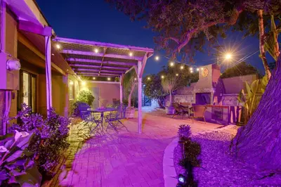 a patio with purple lighting on a house at night at Charming Spring Valley Retreat with Private Pool! in Spring Valley
