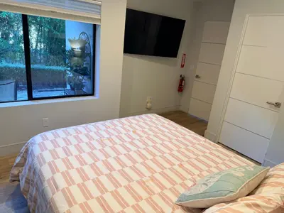a bedroom with a bed and a flat screen tv at Smashing Newly-Built with Ocean/Bay/City Views! in San Diego
