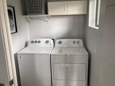 a small laundry room with a washer and dryer at Smashing Newly-Built with Ocean/Bay/City Views! in San Diego