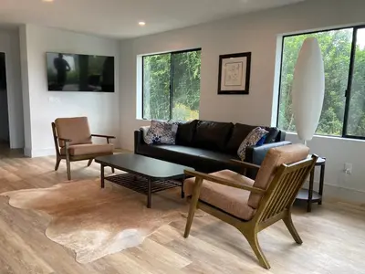 a living room with a couch and chairs and a table at Smashing Newly-Built with Ocean/Bay/City Views! in San Diego