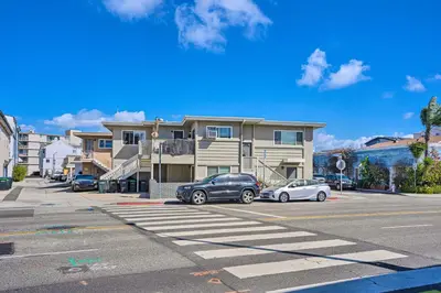 a street with cars parked in front of a house at Newport Beach Vacation Rental - Short Walk to Pier in Newport Beach