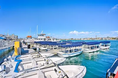a group of boats docked at a dock in the water at Newport Beach Vacation Rental - Short Walk to Pier in Newport Beach