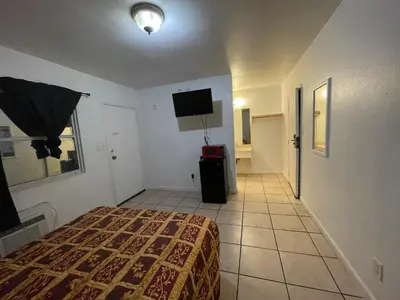 a hotel room with a bed and a television at Crown Inn & Suites in Spring Valley