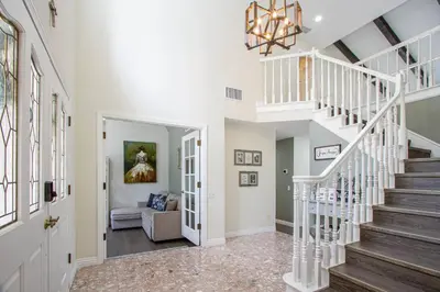 a staircase in a home with a white stair case at Casa Rosé in Temecula
