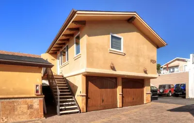 a house with a garage and a staircase on it at Villa D'Arte at the Retreat in Laguna Beach in Laguna Beach